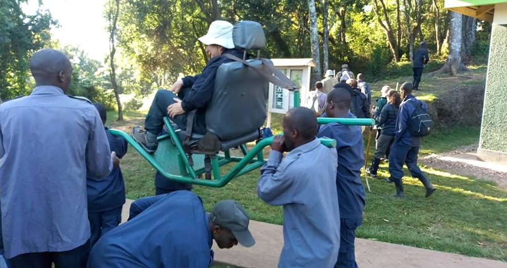 Gorilla Trekking for Disabled. A traveller being carried on a sedan chair to go gorilla trekking in Bwindi.